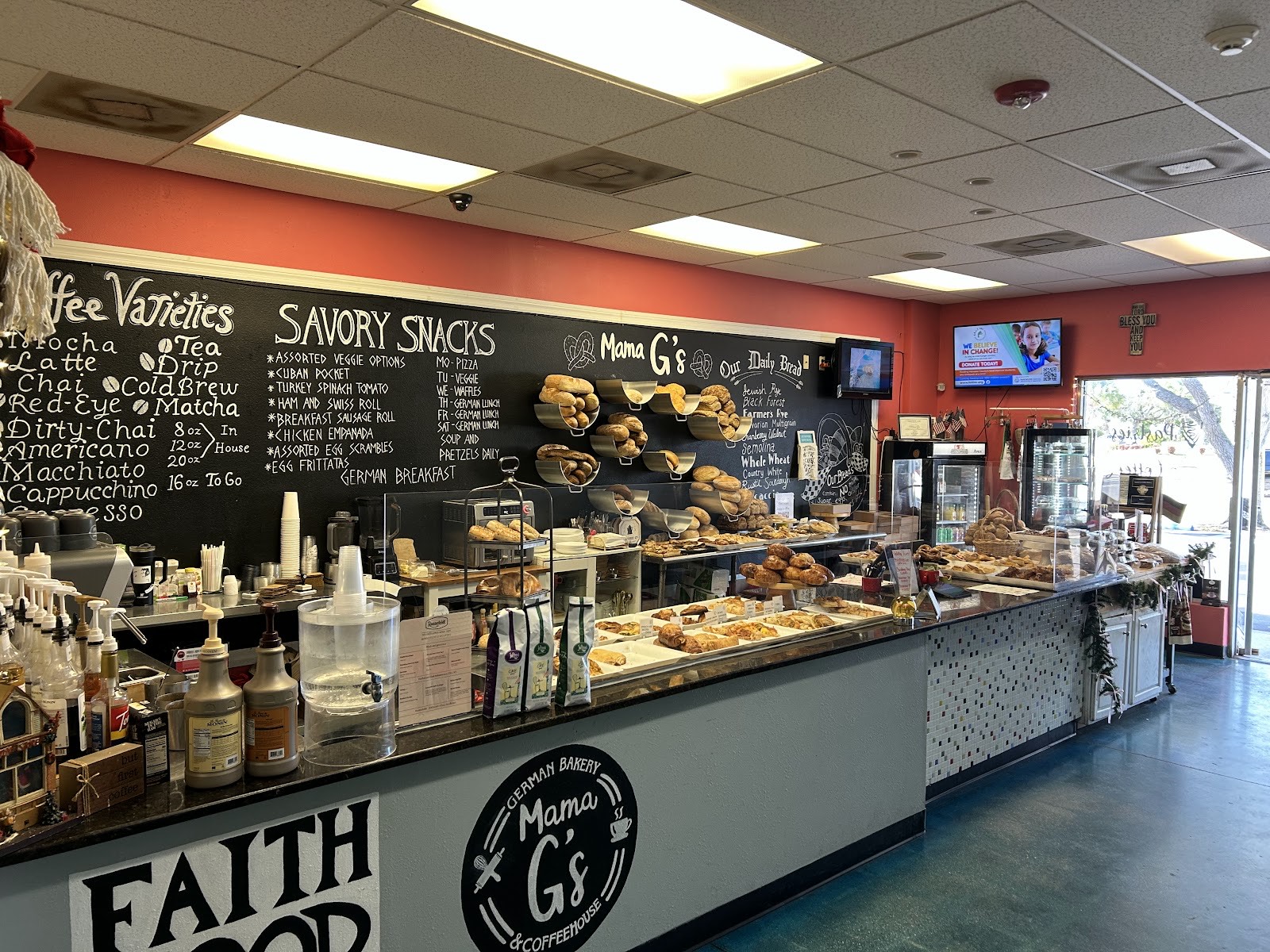 Inside Mama G's: chalkboard menus, pastry case and pink walls