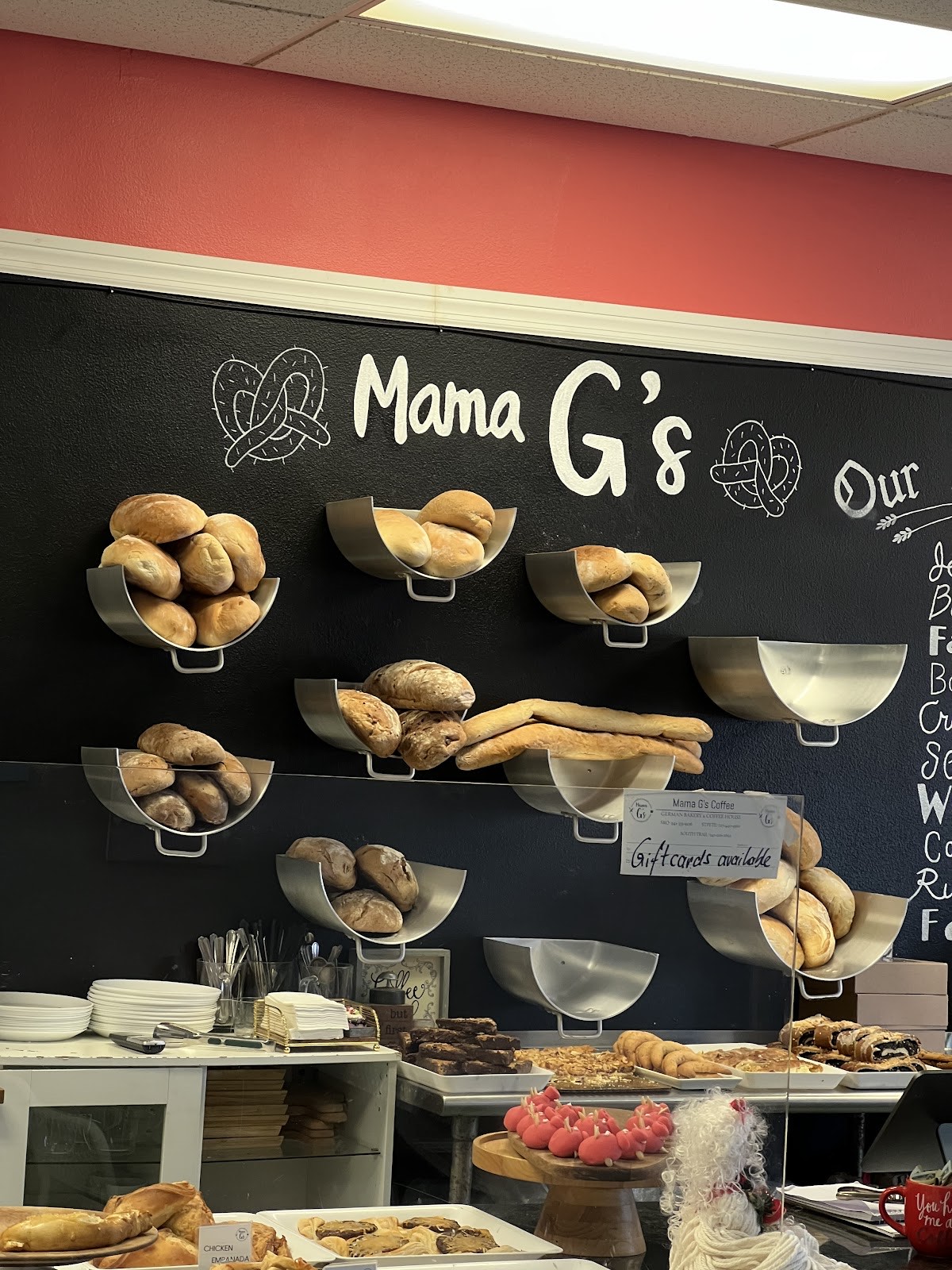 The Mama G's chalkboard wall lined with bowls of fresh-baked German rolls and breads